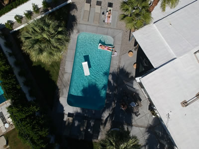 Couple enjoying their backyard swimming pool